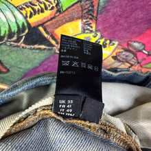 Load image into Gallery viewer, Amiri MX1 Distressed Skinny Camo Jeans Size 33”